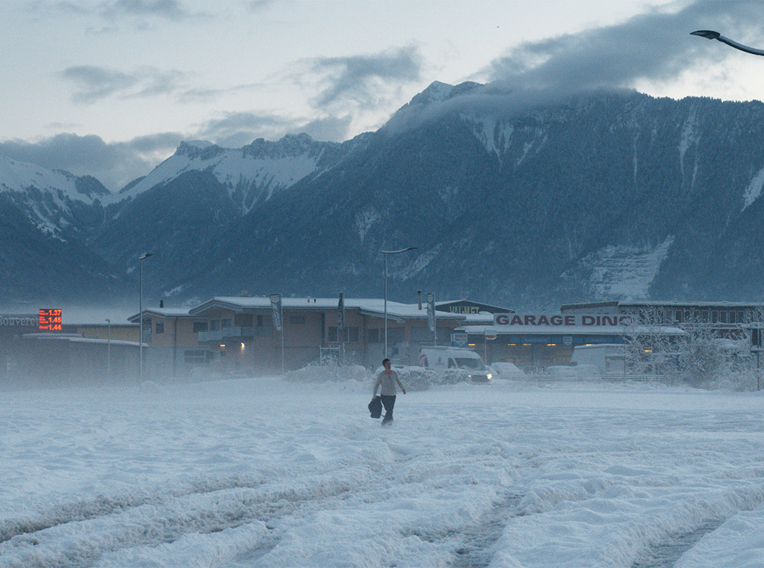 Colour promotional photo for the film ‘The Line’. A woman walks through a snowy landscape.